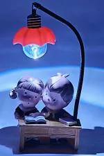 G-Srijan Romantic Valentine Love Couple Together Book Read with Cell Led Lamp Decorative Showpiece - 10 cm (Resin, Polyresin, Multicolor)