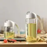 Home Stuffs Olive Oil Glass Bottle Silicone Auto Flip Oil Dispenser Leak Proof Bottles with Non Slip Handle Automatic Cap and Stopper for Kitchen Cooking (Transparent) (600 ML) PACK OF 1