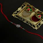 Mahi Rhodium Plated Oranger Crystals Studded Feather-Shaped Rakhi for Brother, Bhai, Bro (RA1100779R)